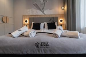 a hotel room with two beds with white pillows at Wielka Krokiew Residence&SPA - Zakopane - JACUZZI, SAUNA, TĘŻNIA SOLANKOWA, SPA, GRILL in Zakopane +92 photos