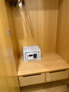 a microwave sitting on top of a wooden shelf at Hotel & Residence Alphaville in Barueri