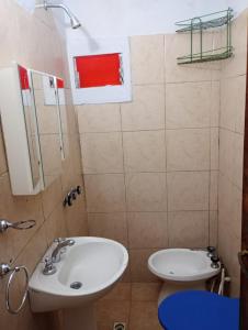 a bathroom with a sink and a toilet at La Carioca in Villa Gesell +11 photos
