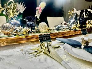a table with a white table cloth with a christmas centerpiece at OJ Home in Vojens