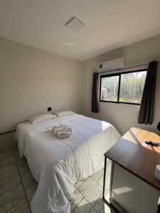 Llit o llits en una habitació de Périco Hotel