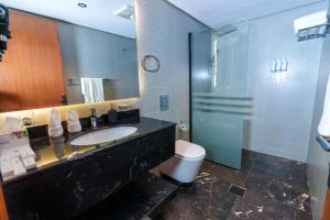 a bathroom with a sink and a shower and a toilet at فندق شادن الفخامة in Taif