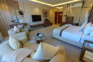 a hotel room with two beds and a television at فندق شادن الفخامة in Taif +12 photos