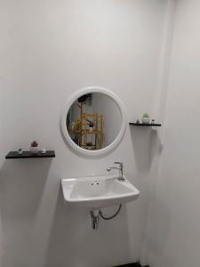 a white bathroom with a sink and a mirror at Langkao Homestay Kohlibong หลังเขาโฮมสเตย์ เกาะลิบง in Ko Kwang +21 photos
