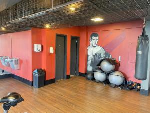 a boxing gym with a wall with a picture of a boxer at Fully equipped apt: A/C, pool & gym in Downtown in Taubaté