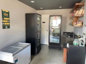 a large black refrigerator in a kitchen with a freezer at Fully equipped apt: A/C, pool & gym in Downtown in Taubaté