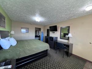 a hotel room with a bed and a desk at Deerfield inn & Suits in Smyrna +7 photos