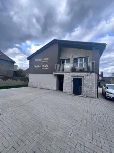 a building with a car parked in front of it at Apartmány Perfect Home in Česká Lípa