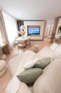 a living room with a large white couch with pillows at Wabi Sabi Nest in Timişoara
