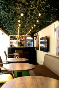 a restaurant with tables and chairs and a bar at Five Clover Hotel, Ilupeju in Lagos