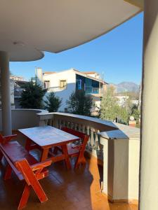 a patio with a table and chairs on a balcony at Balkan Hostel in Tirana