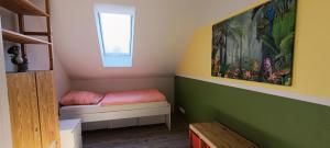 a small room with a small bed and a window at Modern Doppelhaus in Baunatal