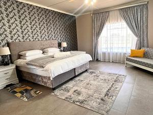 a bedroom with a large bed and a window at The Bloemhof Stay in Bloemhof +18 photos