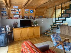 a living room with a staircase and a television at Vikendica Stojanović in Mionica
