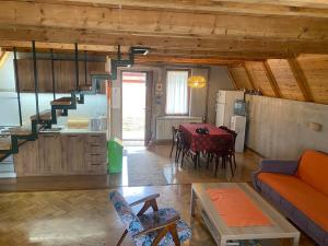 a living room with a couch and a table and a kitchen at Vikendica Stojanović in Mionica