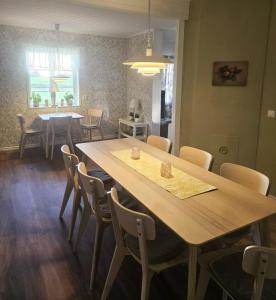 a dining room with a wooden table and chairs at Villa Freja in Linköping