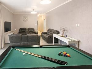 a living room with a pool table in a room at The Bloemhof Stay in Bloemhof