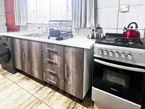 a kitchen with a stove and a sink at The Bloemhof Stay in Bloemhof