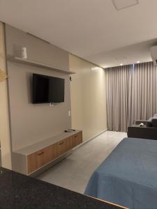 a hotel room with a bed and a flat screen tv at Flat em Alter do Chão in Alter do Chao +43 photos