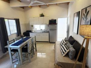 a kitchen and living room with a table and a couch at Dpto Centrico 2 Hab con Split Frío Calor cada Habitación in Mercedes +9 photos