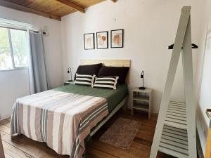 a bedroom with a bed with a striped bedspread at Dpto Centrico 2 Hab con Split Frío Calor cada Habitación in Mercedes