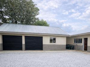 a garage with two garage doors on a house at The Bloemhof Stay in Bloemhof