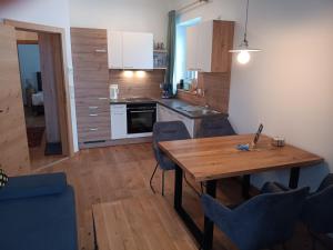 a kitchen and dining room with a wooden table and chairs at Top 103 Lärchenhof in Mauterndorf