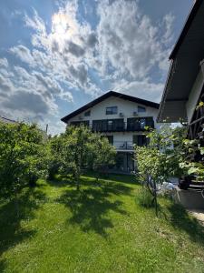 a building with a yard with trees in front of it at Гостинний двір in Yaremche