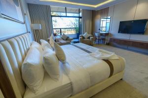 a large bedroom with a large bed with white pillows at فندق شادن الفخامة in Taif