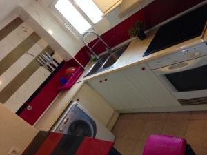 a kitchen with a washing machine in a room at Port Saplaya - Vistas al mar in Port Saplaya