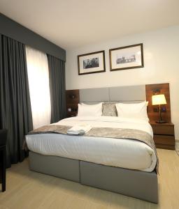 a bedroom with a large bed and a window at Five Clover Hotel, Ilupeju in Lagos