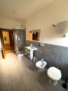 a bathroom with a toilet and a sink at Flowers & Angels Home in Santa Maria degli Angeli