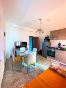 a kitchen and dining room with a table and chairs at Flowers & Angels Home in Santa Maria degli Angeli