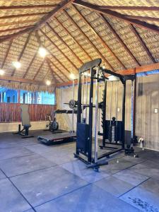 a gym with two treadmills and a treadmill at POUSADA AMORIM in Santo Amaro