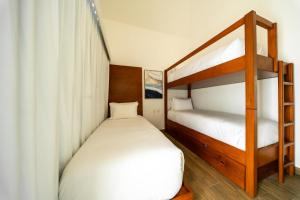 two beds in a room with two bunk beds at Designer Villa with Direct Pool Access in Monterrico +11 photos