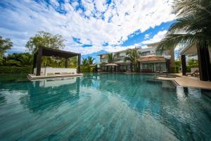 an infinity pool in a villa with blue water at Designer Villa with Direct Pool Access in Monterrico