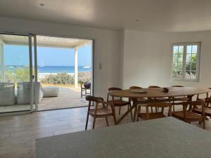 a dining room with a table and a view of the ocean at Exceptional Waterfront Villa in Hyères