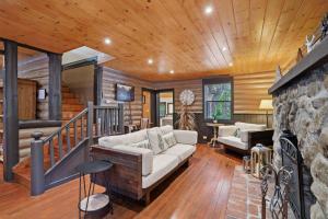 a living room with a couch and a stone wall at Idyllwild Realty Vacations in Idyllwild