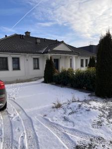 a house with snow in front of a house at Dom Berry in Chrzanow