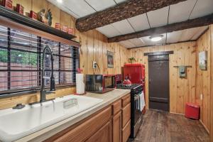 a kitchen with a sink and a microwave at Idyllwild Realty Vacations in Idyllwild +203 photos