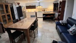 a kitchen and dining room with a table and a couch at Chez Mich'An Luberon in Saignon