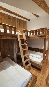two bunk beds in a room with a ladder at Chalet Schernthann in Salvenberg