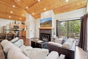 a living room with white furniture and a fireplace at Idyllwild Realty Vacations in Idyllwild