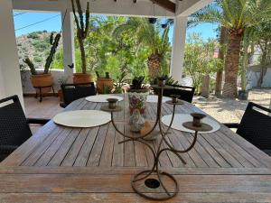 a wooden table with chairs on a patio at ArteVida Andalusia FKK Nudist Holiday with yoga and massage in Mojácar