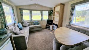 a living room with a couch and a table at Dinas in Llanbedr +36 photos