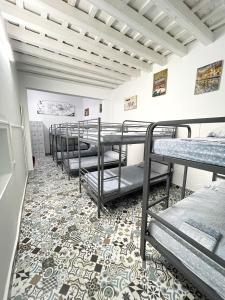 a row of bunk beds in a room at Rosa de los Vientos in Cádiz