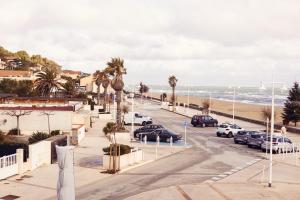 a street with cars parked on the beach at HOTEL RESTAURANT LA COTE REVEE in Leucate