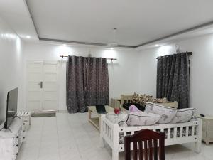 a living room filled with furniture and curtains at Mobi house Malindi in Malindi