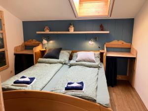 a bedroom with two beds and shelves on the wall at Dachstein Stüberl in Bad Aussee