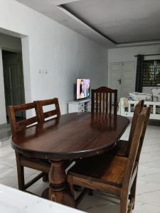 a dining room with a wooden table and chairs at Mobi house Malindi in Malindi